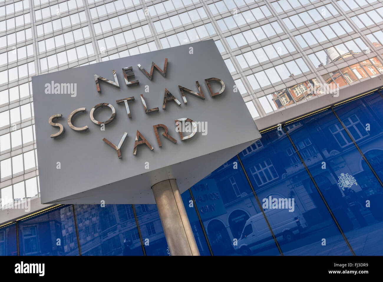 This triangular, revolving, sign stands outside New Scotland Yard which is the headquarters of the Metropolitan Police Service. Stock Photo