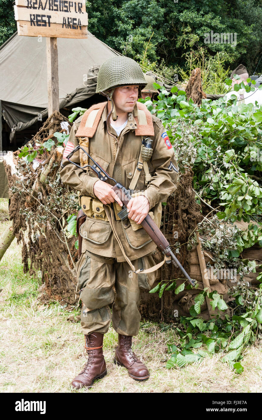 War and Peace show, England. Second World War re-enactment. American GI standing on sentry duty, holding rifle, while standing outside rest area. Stock Photo