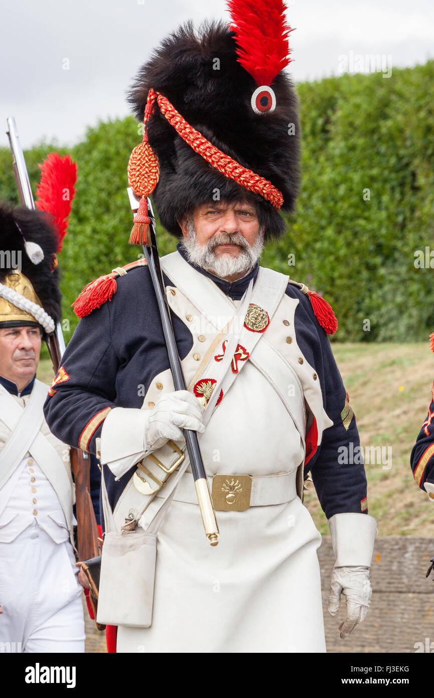 Re-enactment, Napoleonic wars, French Imperial Guard, senior officer marching with swagger stick held against shoulder. Eye-contact. Close up. Stock Photo