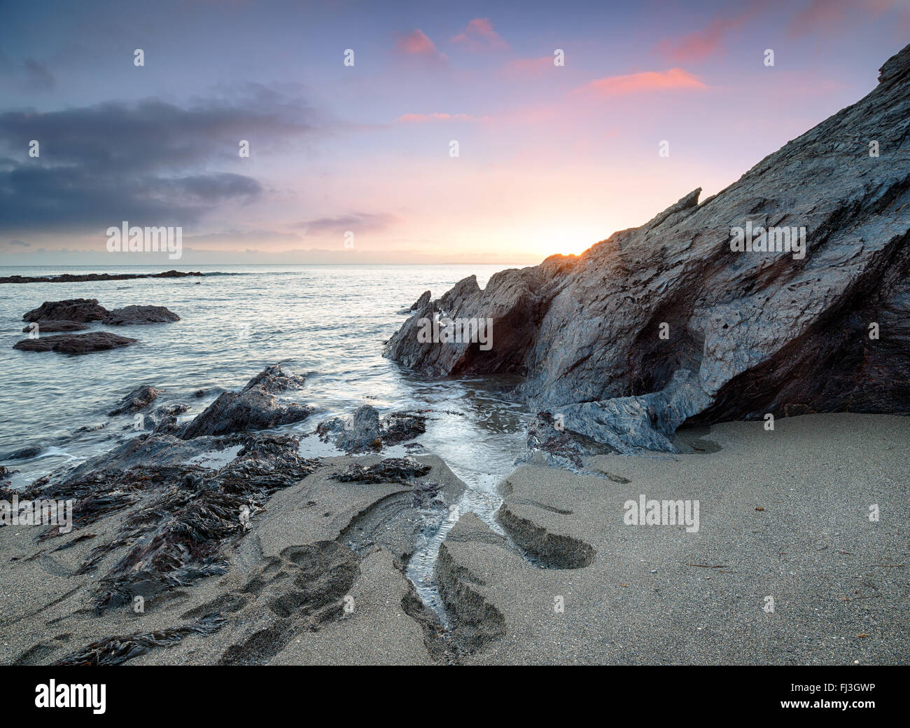 Sunset on the beach at Hemmick on the south coast of Cornwall Stock Photo
