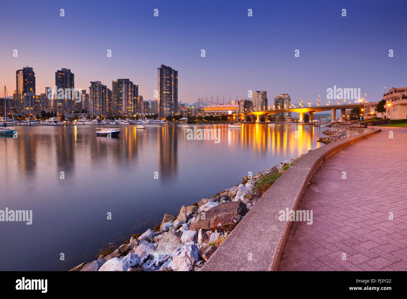 The skyline of Vancouver, British Columbia, Canada from across the water at dusk. Stock Photo