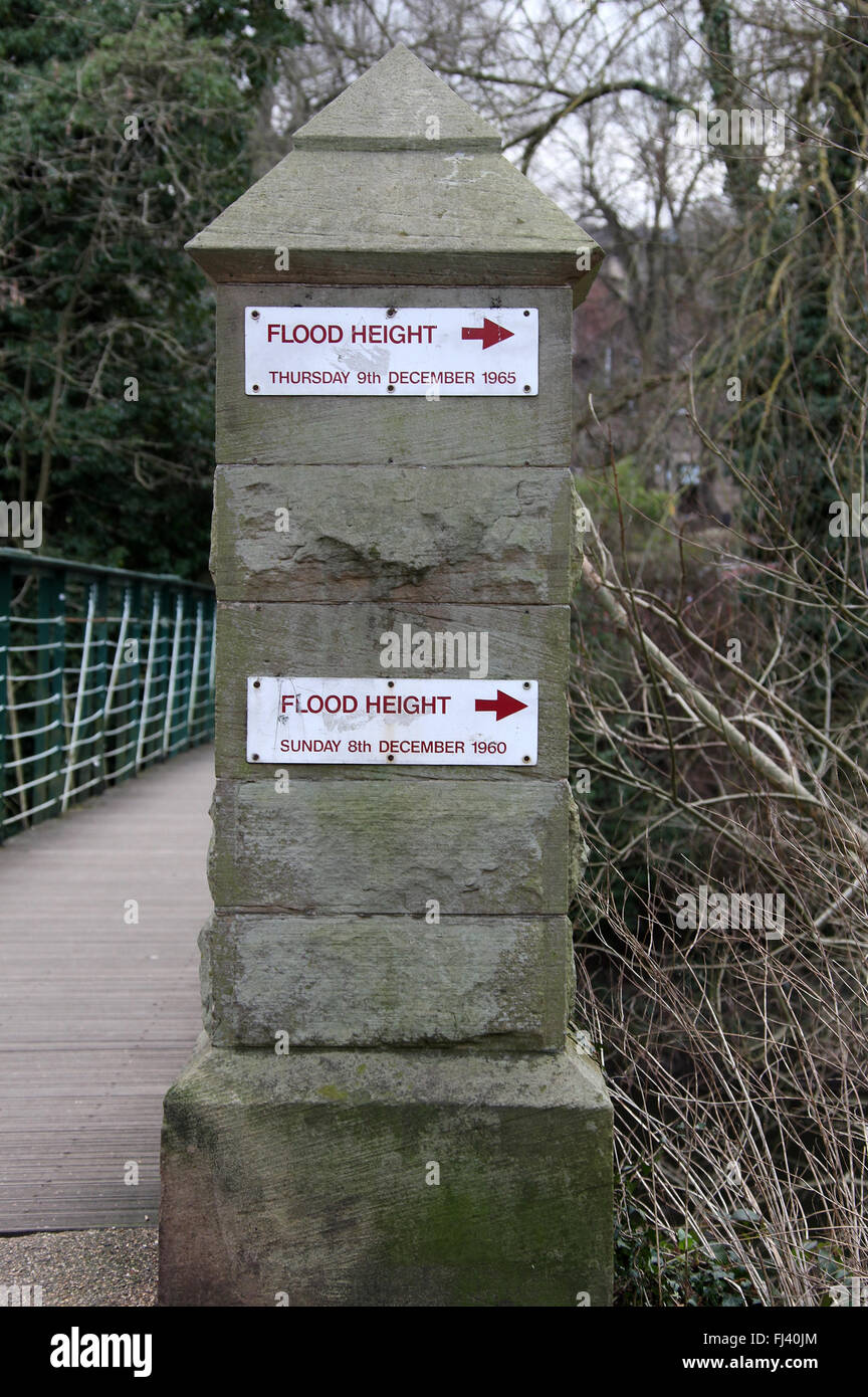 Flood marker on a footbridge over the River Derwent at Hall Leys Park in Matlock Stock Photo