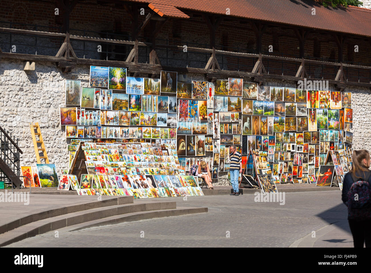Wall of paintings for sale by local artists outside St. Florian's Gate