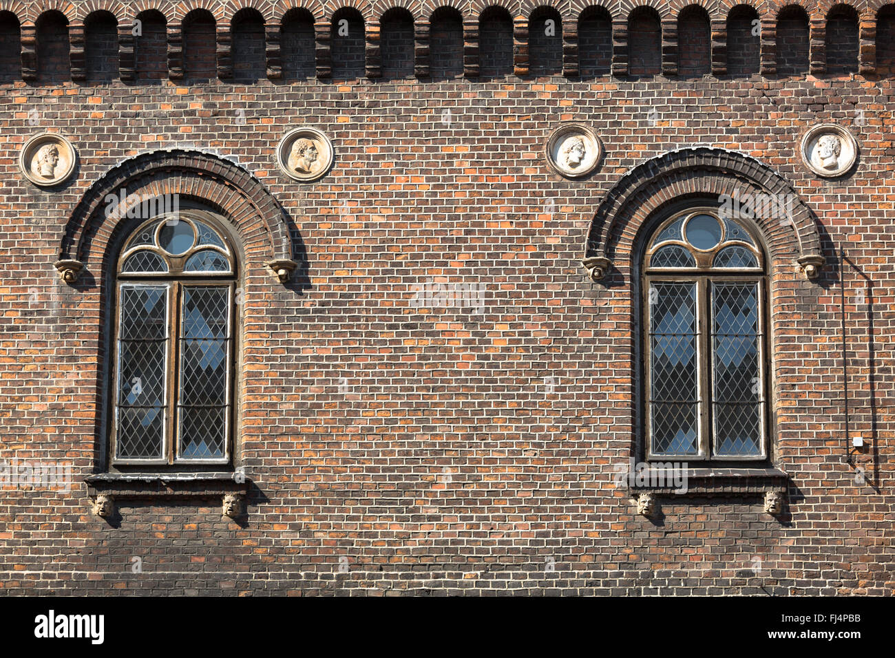 Cross hatch styled windows on a brick building - Krakow, Poland Stock ...