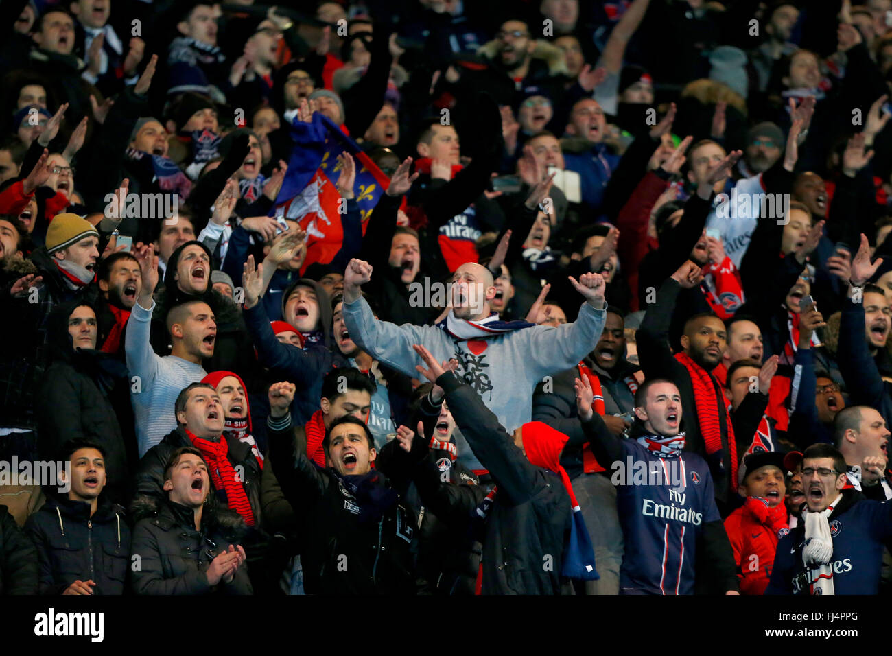 PSG fans singing during the UEFA Champions League round of 16 match between Paris Saint-Germain and Chelsea at the Parc des Princes Stadium in Paris. February 16, 2016. James Boardman / Telephoto Images +44 7967 642437 Stock Photo