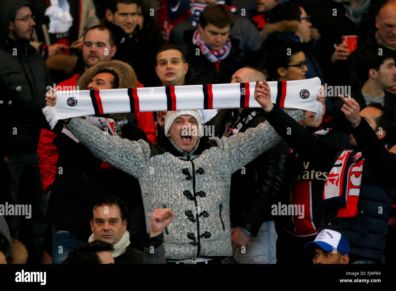 PSG fans singing during the UEFA Champions League round of 16 match between Paris Saint-Germain and Chelsea at the Parc des Princes Stadium in Paris. February 16, 2016. James Boardman / Telephoto Images +44 7967 642437 Stock Photo