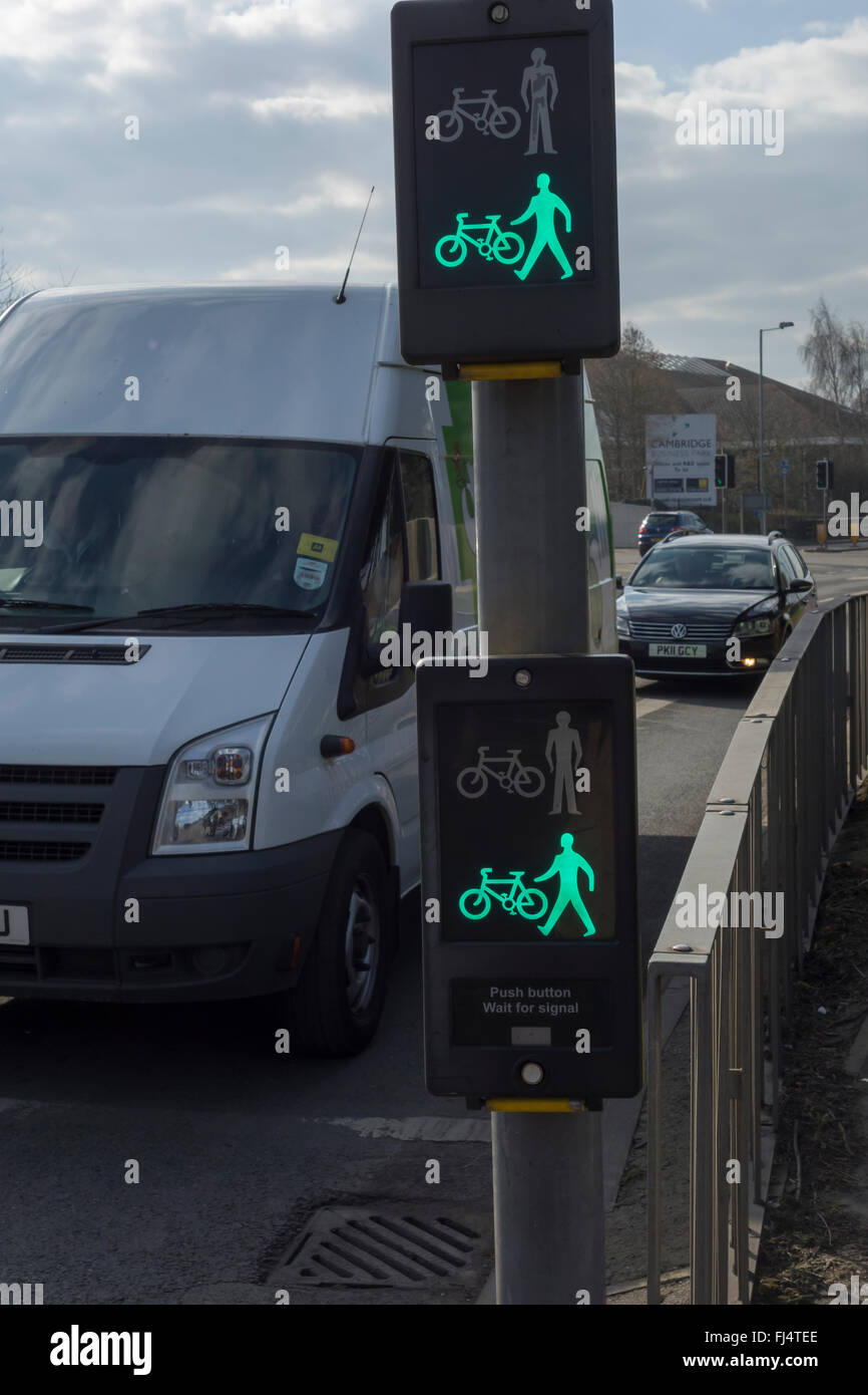 Pedestrian and cyclist crossing sign showing green to cross now Stock Photo