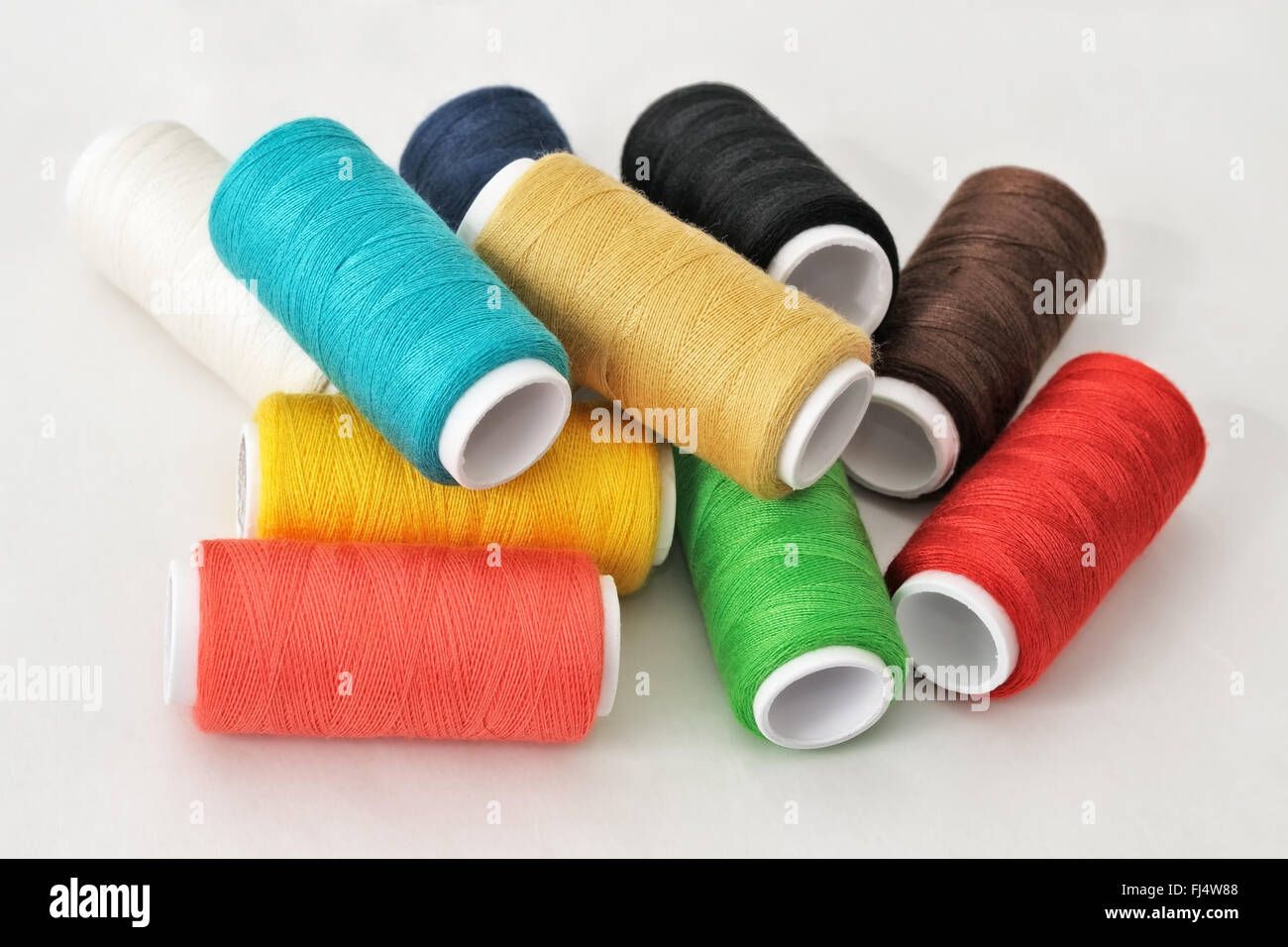 Light Colour Threads Spools of threads of different colors on light table Stock Photo - Alamy