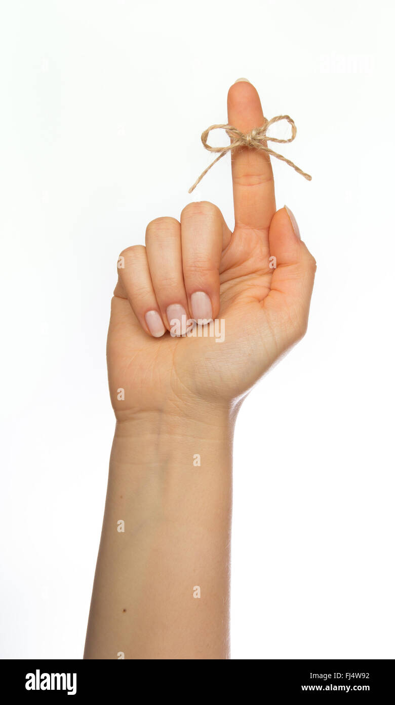 Woman's hand  with reminder string around pointing finger Stock Photo