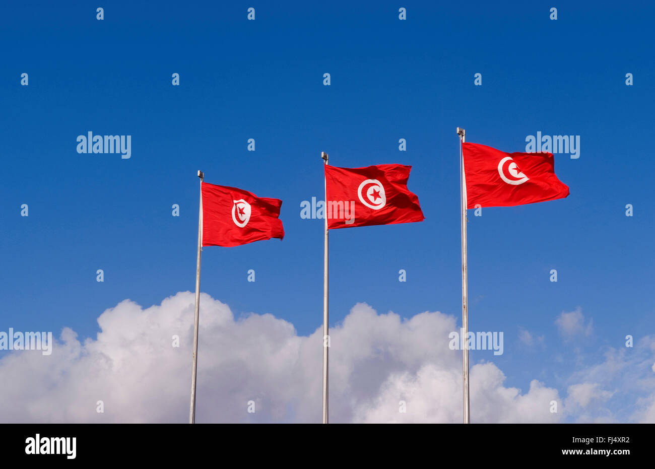 Three Tunisia national flags blowing in the wind at Tunis Airport, Tunisia Stock Photo