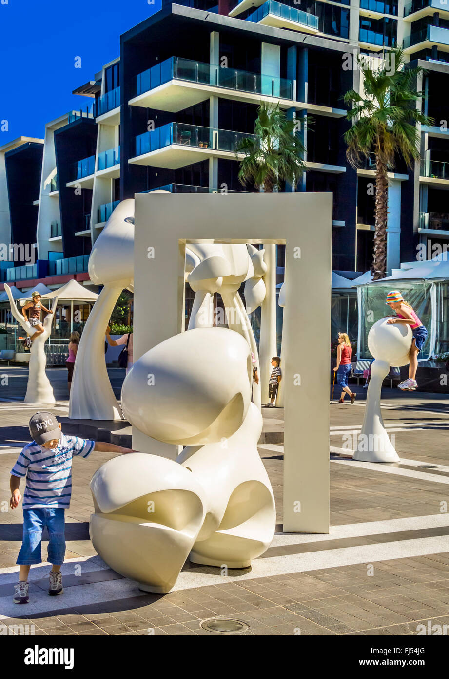 Children playing amongst contemporary Public art sculpture installation, "Silence", in Docklands