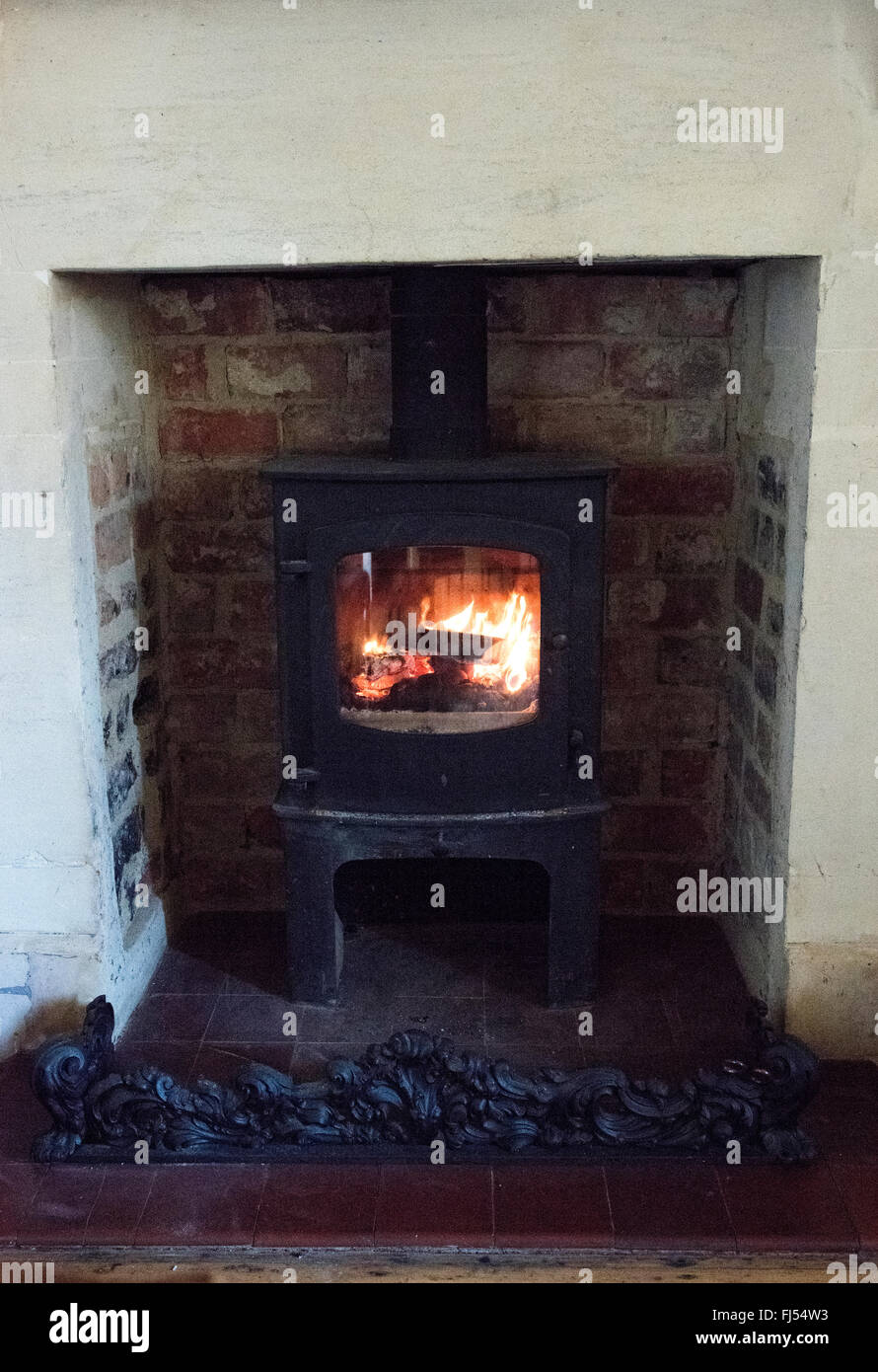 A closeup shot of pieces of wood burning inside old metal oven Stock Photo  - Alamy