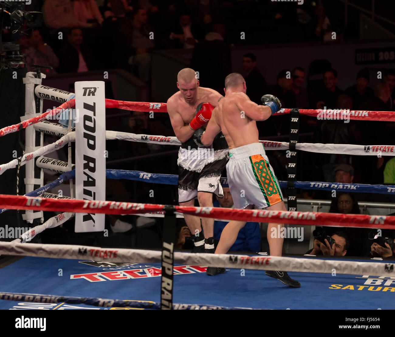 May 28, 2016; Clay Burns (blue trunks) and Isaac Avalos (black trunks) box  during their lightweight boxing match at Gila River Arena in Glendale, AZ.  Burns won via second round TKO. Joe