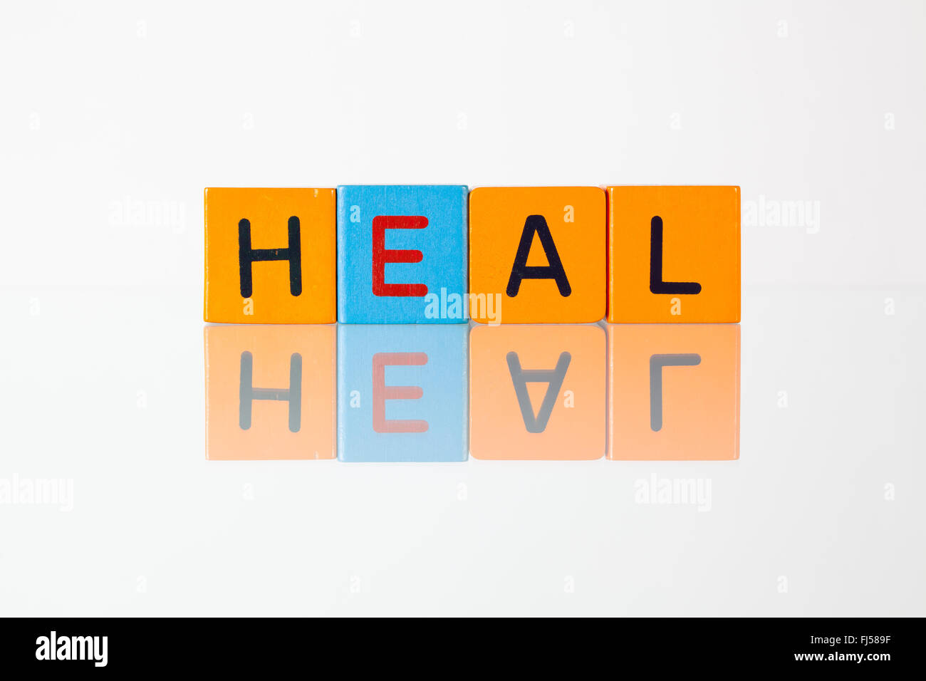 Heal - an inscription from children's wooden blocks Stock Photo