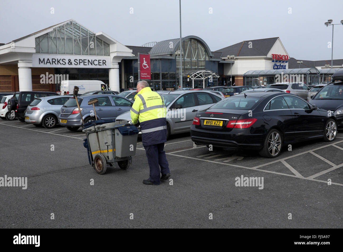 a customer assistance helper working in the car parkat handforth dene shopping outlets Stock