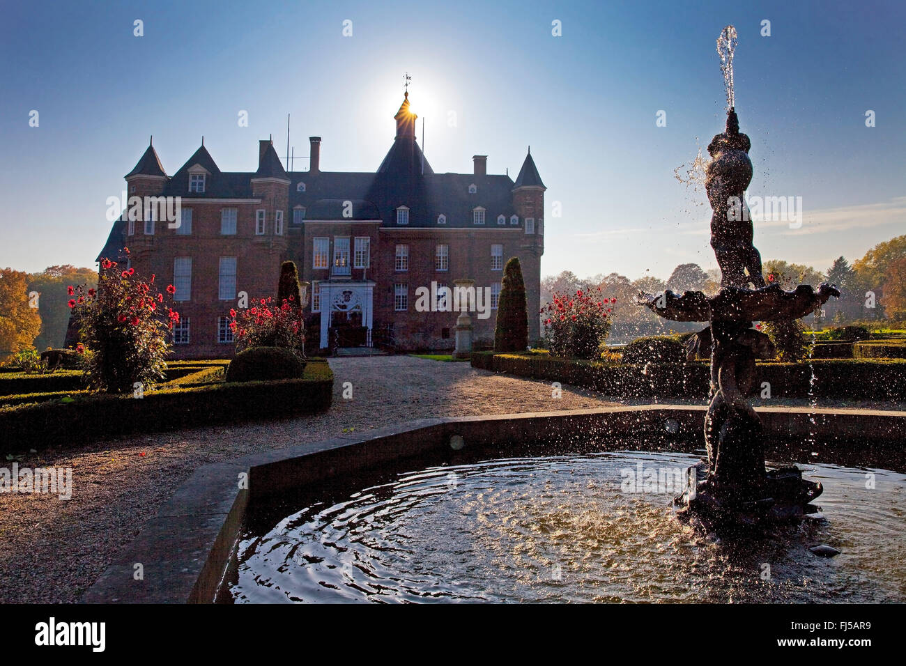 fountain on front of castle Anholt, French formal garden, Germany, North Rhine-Westphalia, Muensterland, Isselburg-Anholt Stock Photo