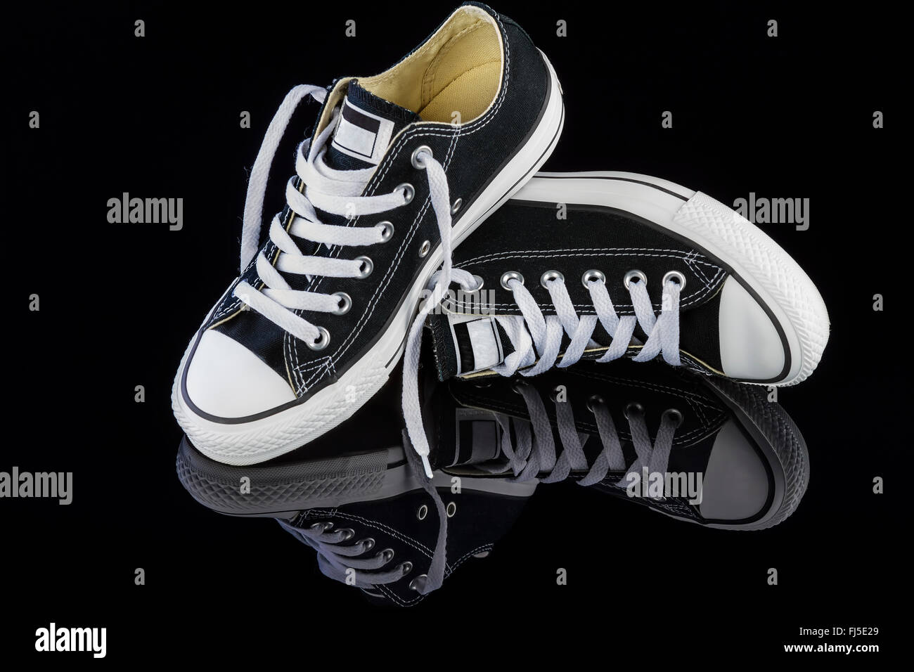 Black sneakers on black background Stock Photo