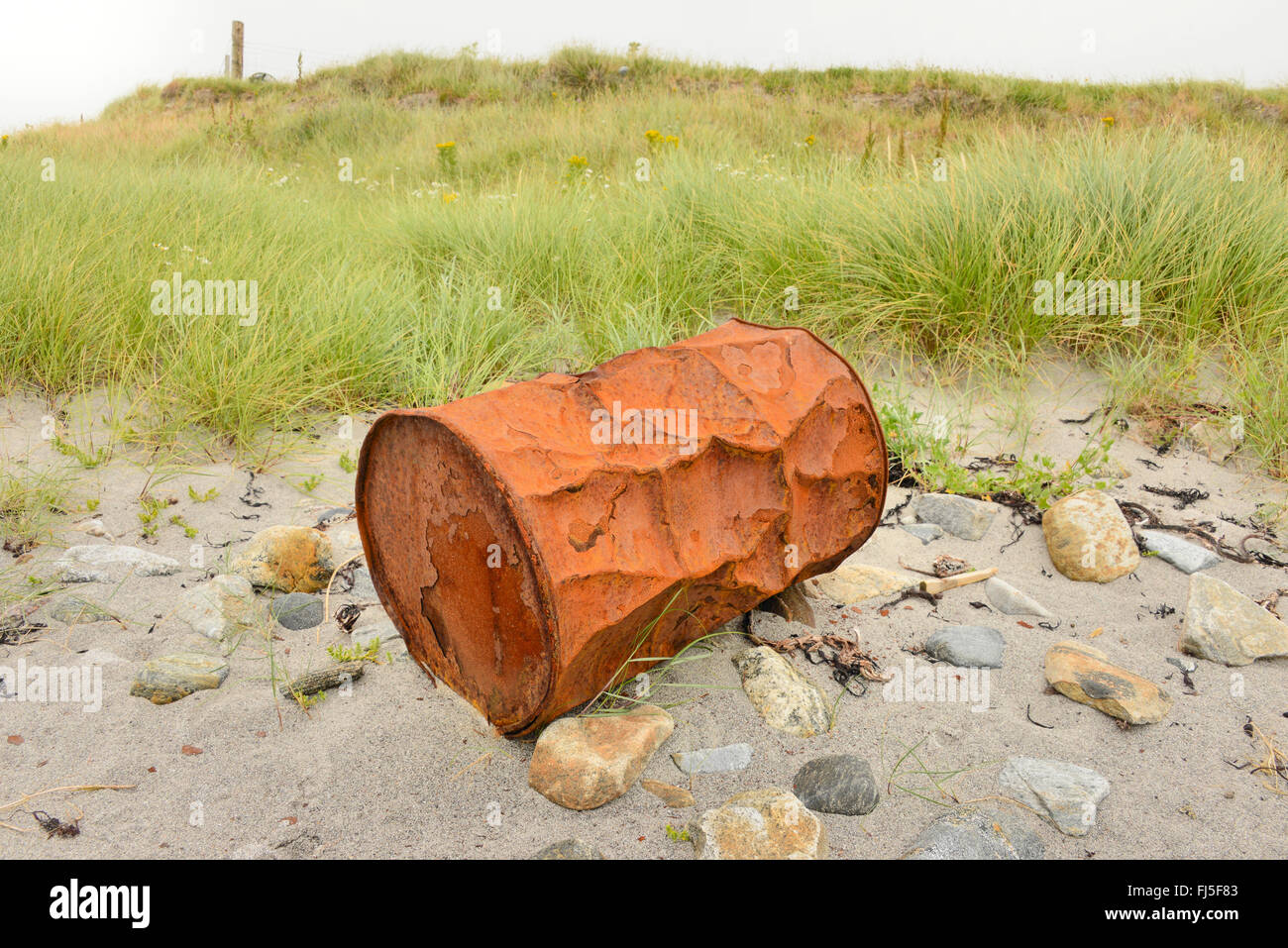 Rusty battered oil drum on a South Uist beach, Outer Hebrides, Scotland Stock Photo