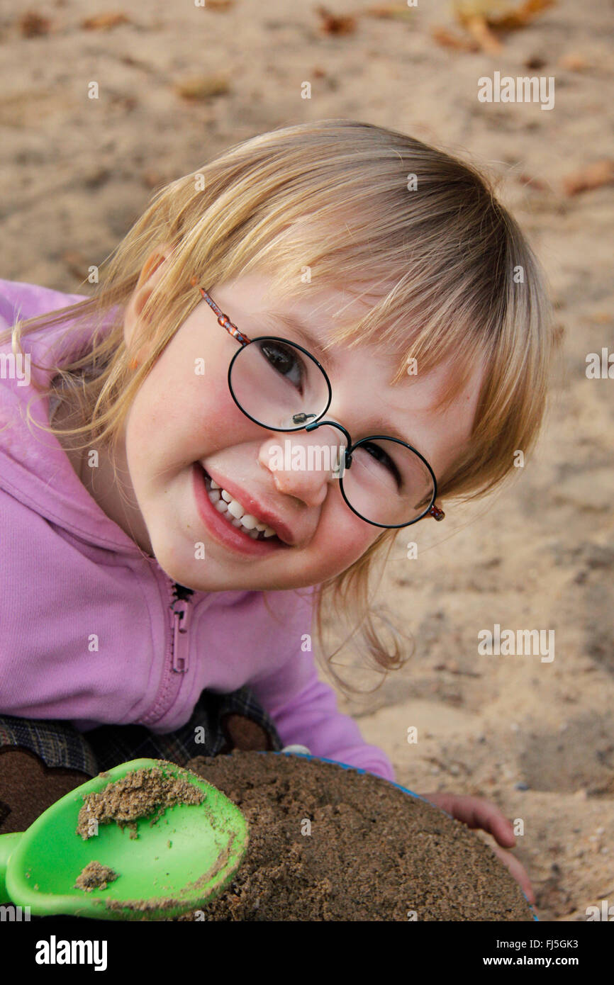 little girl playing in the sand, portrait of a child Stock Photo