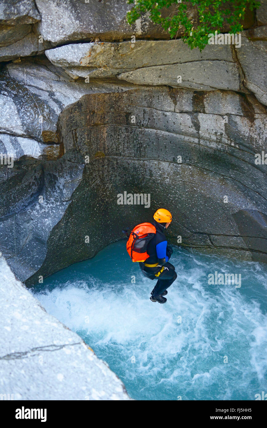 man jumping into mountain river in the canyon of Ecot, France, Savoie, Bonneval sur Arcs Stock Photo