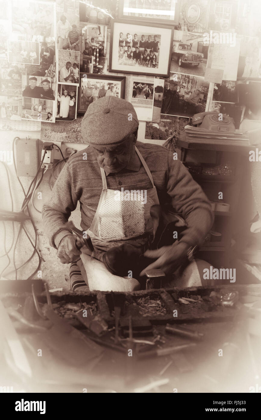 Cobbler at work practicing his craftsmanship with traditional tools in