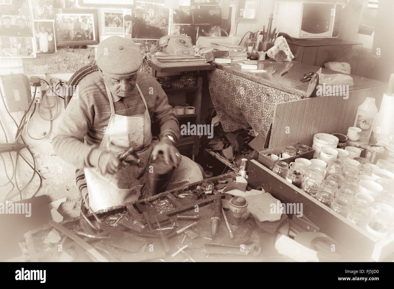 Cobbler at work practicing his craftsmanship with traditional tools in