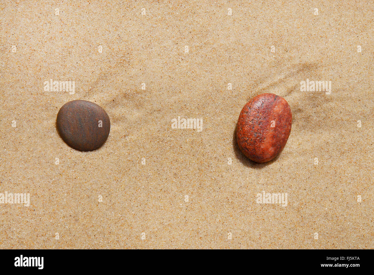 two rounded stones on sandy beach, Denmark Stock Photo - Alamy