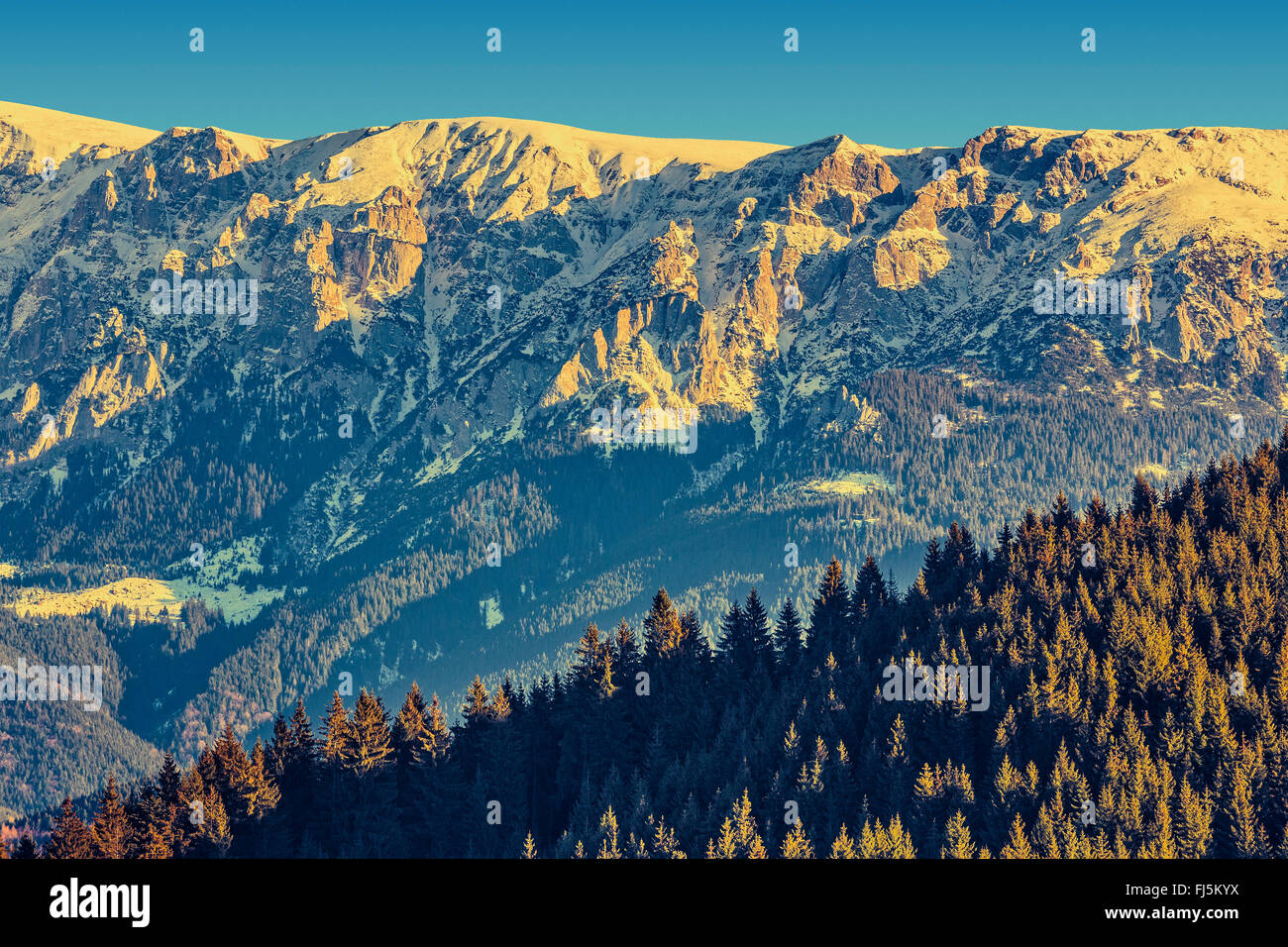 Picturesque landscape of sunlit Bucegi mountains ridge with steep ...