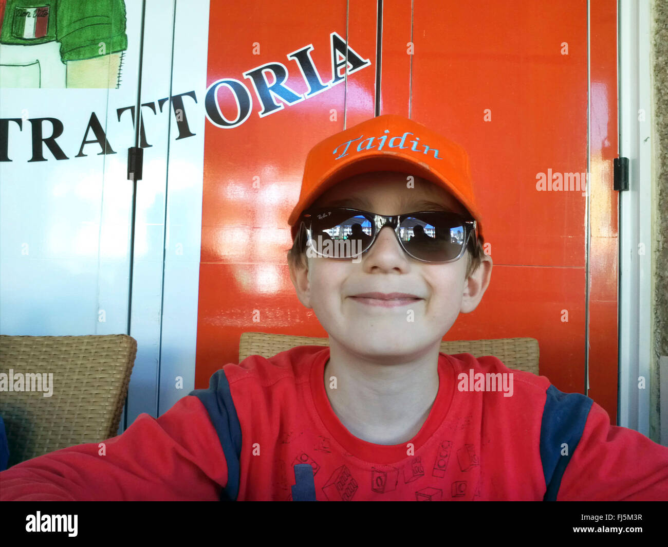 cool boy with sunglasses in a trattoria Stock Photo