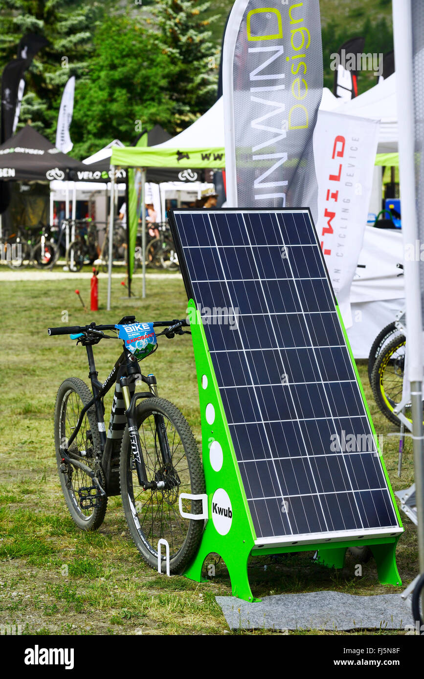 Electric bike charging with solar electric power, France, Savoie Stock Photo