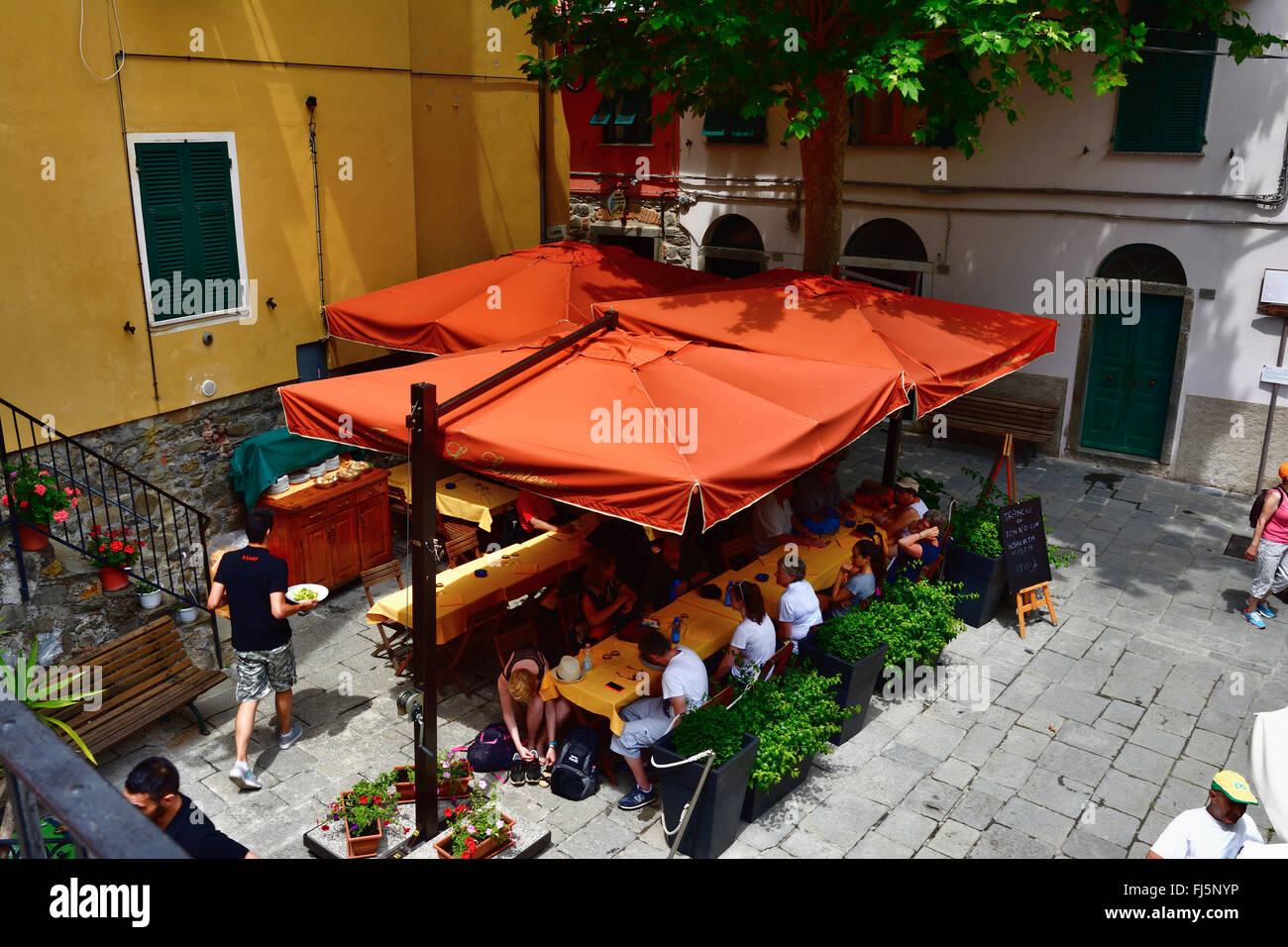People eating traditional italian food in outdoor restaurant of
