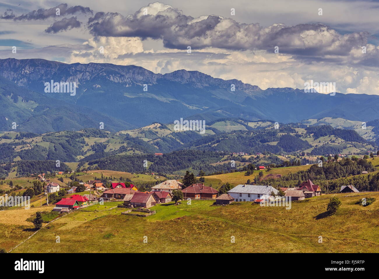 Beautiful rural landscape with traditional Romanian mountainous houses in the valleys of the Bucegi mountains in Pestera village Stock Photo