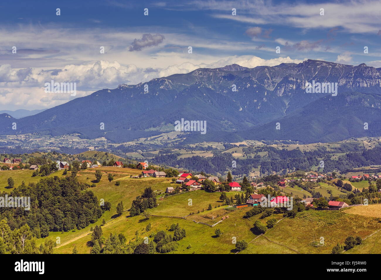Country landscape with traditional Romanian mountainous village in the valleys of the Bucegi mountains in Pestera, Brasov county Stock Photo
