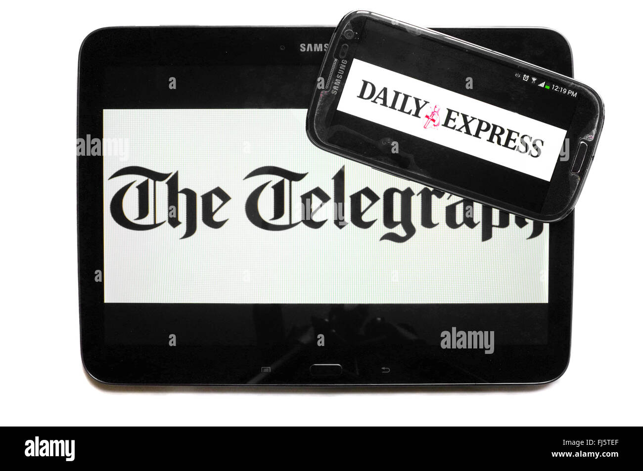 The logos of The Telegraph and the Daily Express newspapers displayed on the screens of a tablet and a smartphone. Stock Photo