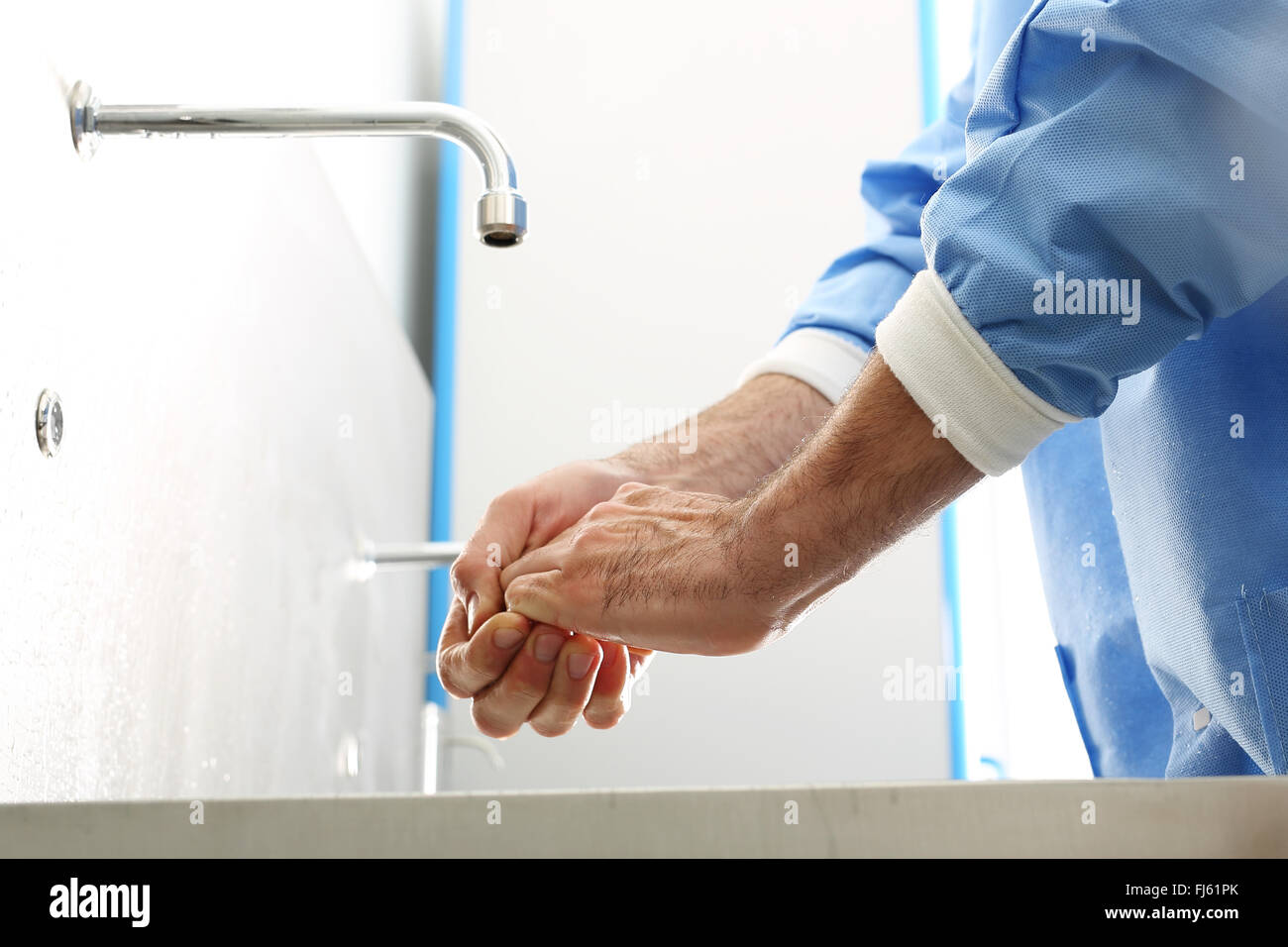 Surgeon washing hands. The doctor washes his hands, disinfect their