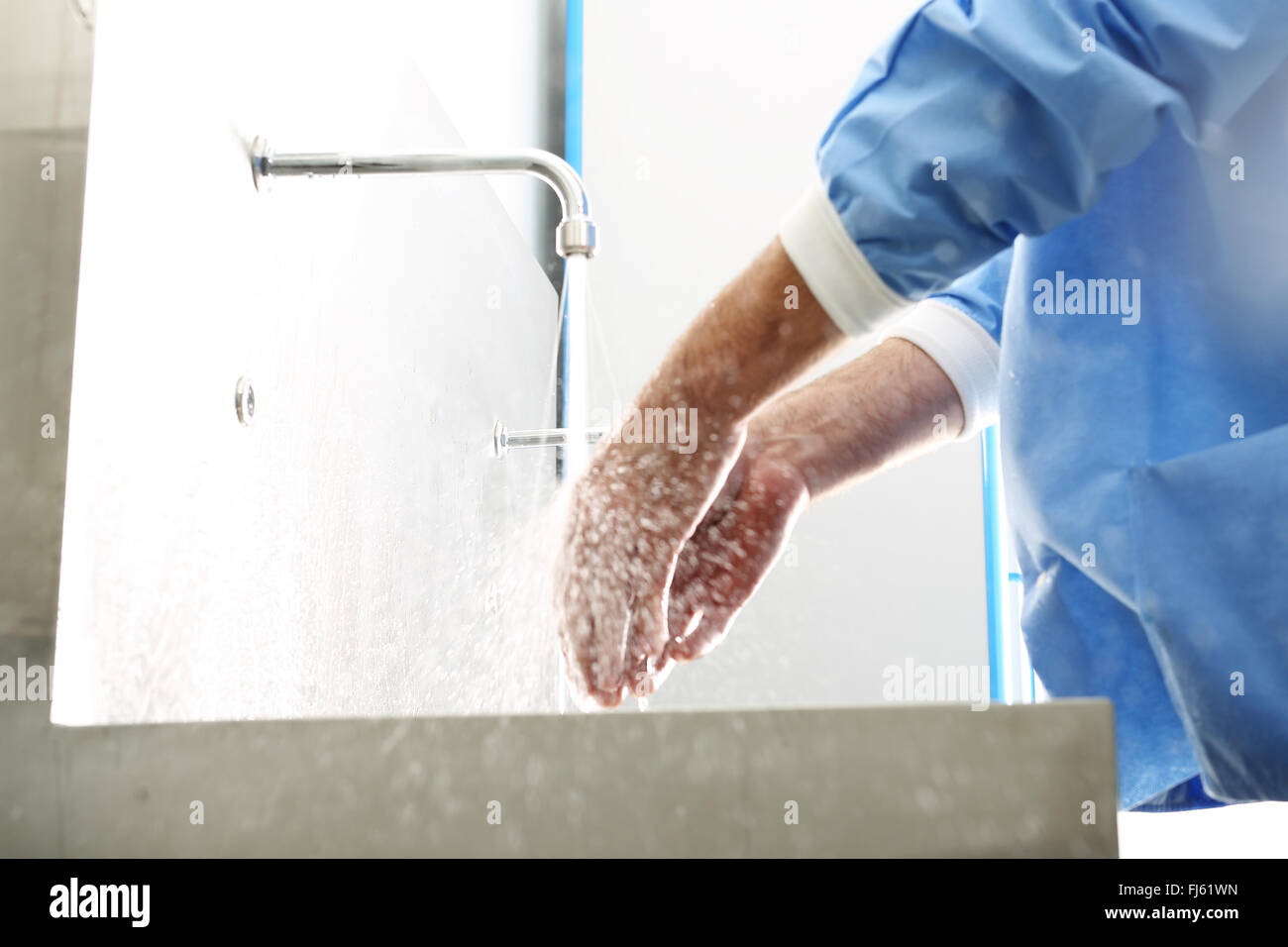 Surgeon washing hands. The doctor washes his hands, disinfect their