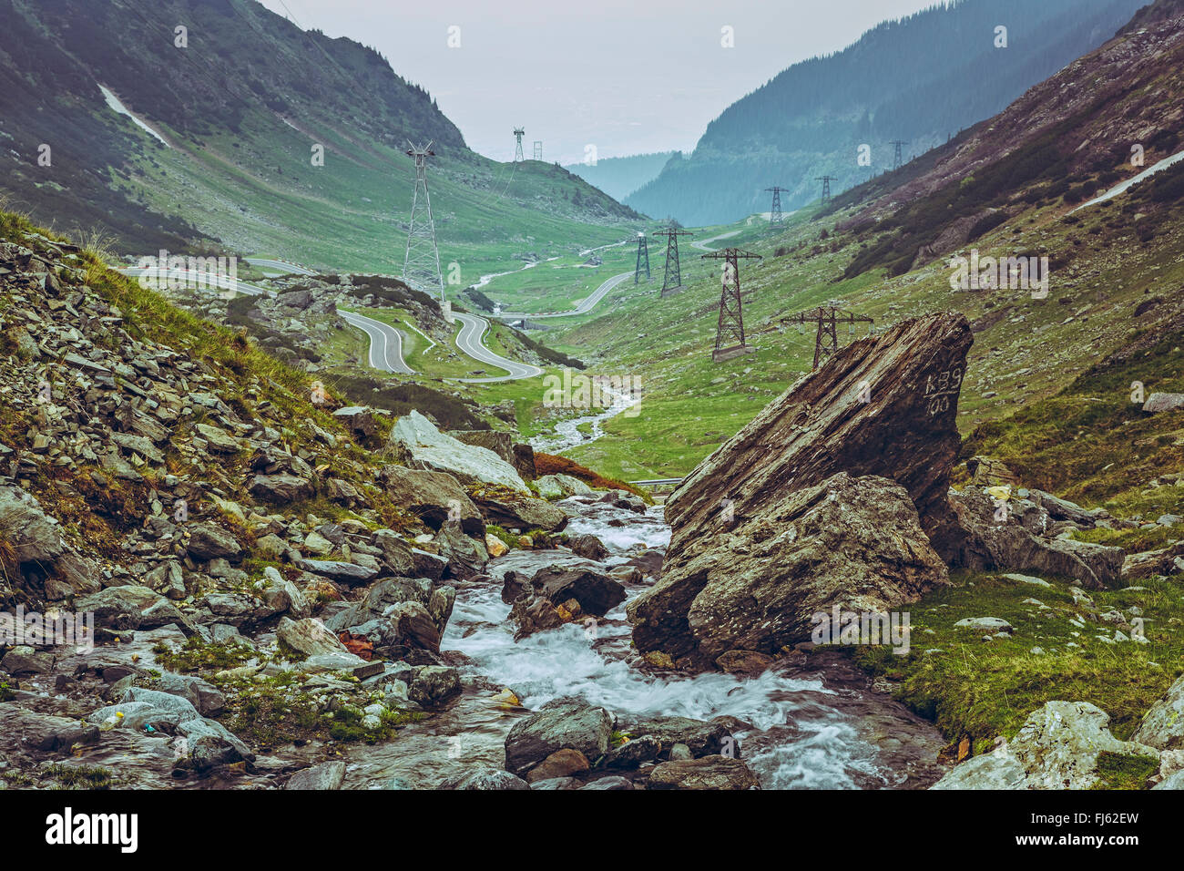 Scenic vista with fresh water stream rapids flowing along the famous sinuous Transfagarasan road in Fagaras mountains, Romania. Stock Photo