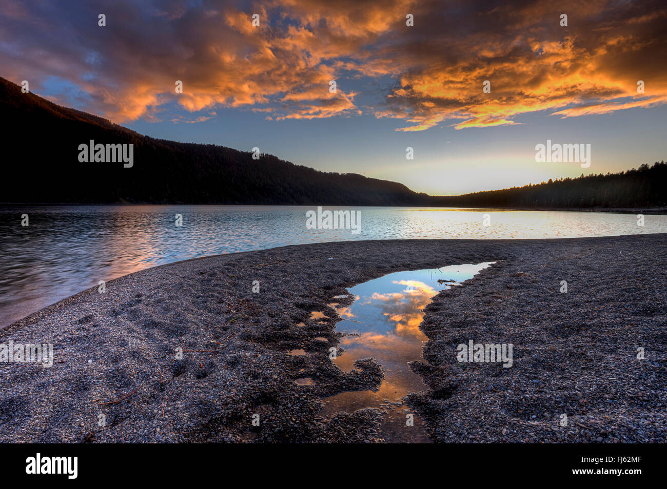 Orange clouds at sunset over the lake Stock Photo - Alamy