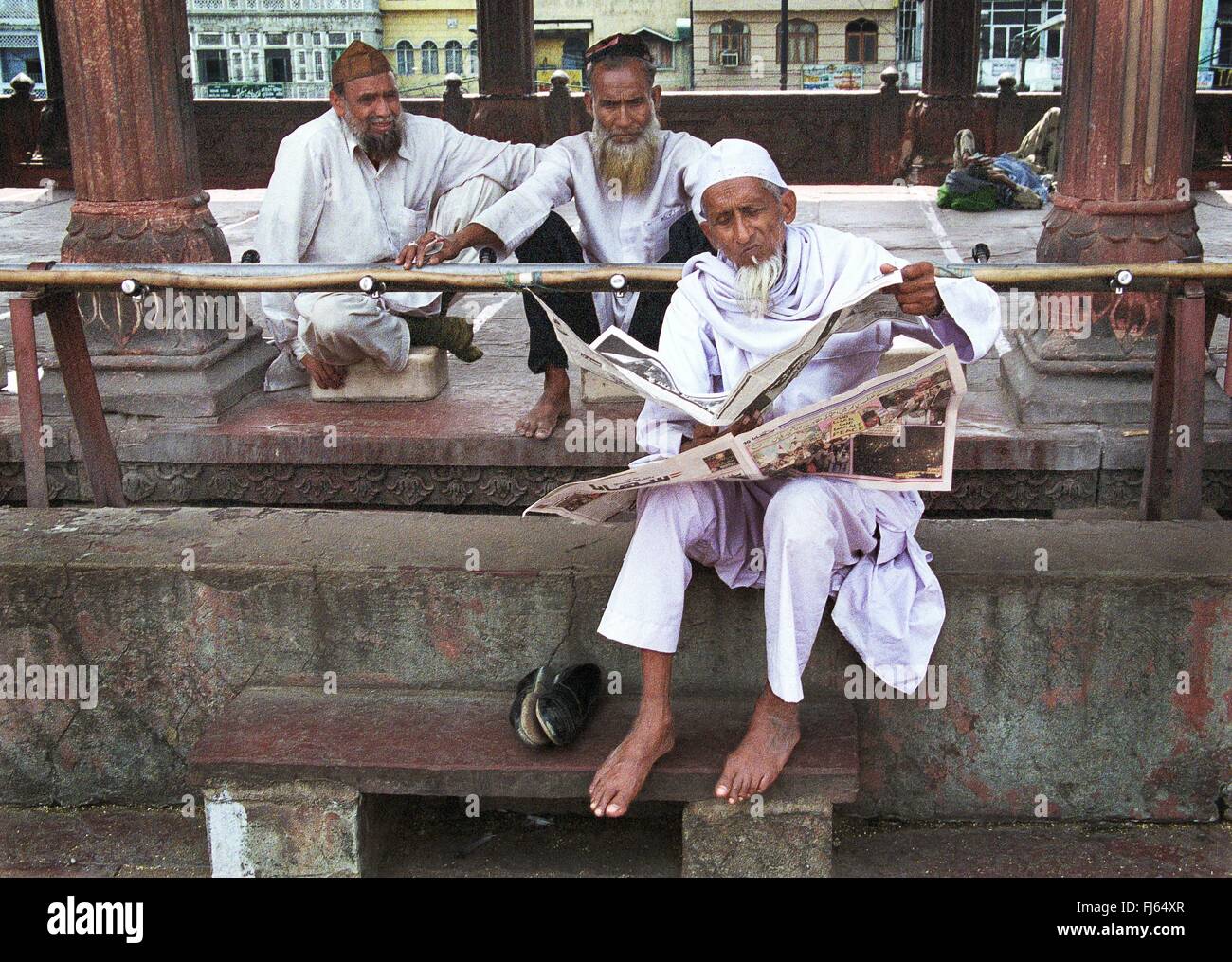 Indian men reading newspaper, India, Delhi, New-Delhi. Stock Photo