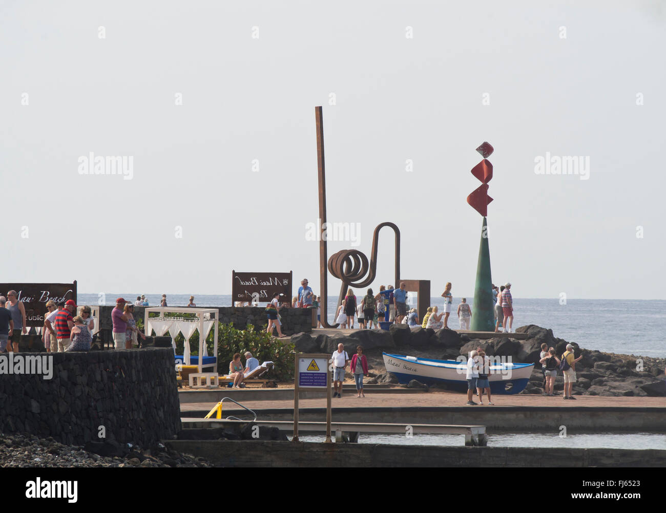 Seaside promenade in Plays las Americas, Tenerife Canary Islands Spain, tourists enjoying a morning walk and art installations Stock Photo