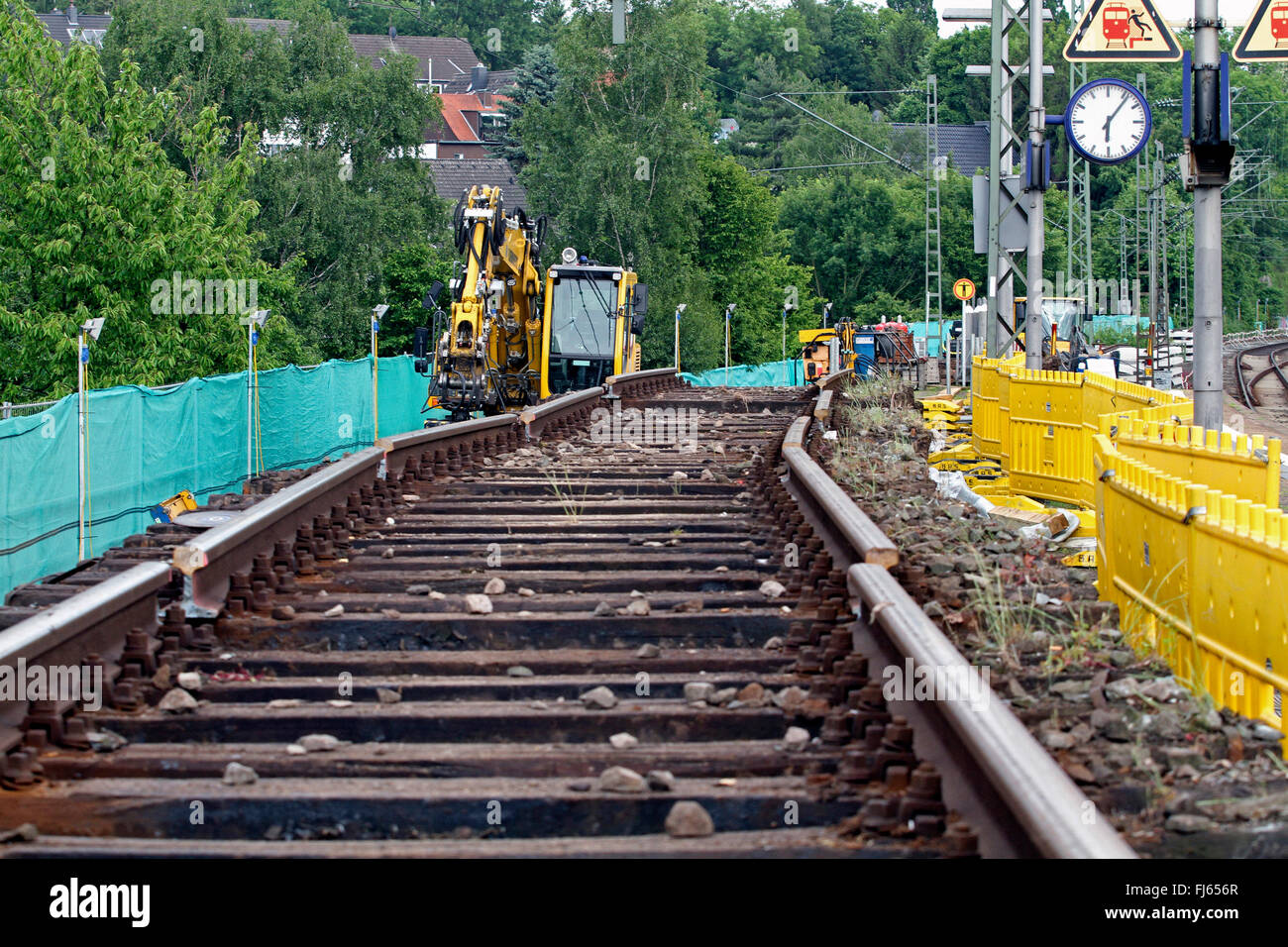 old railway tracks and two-way excavator, Germany Stock Photo