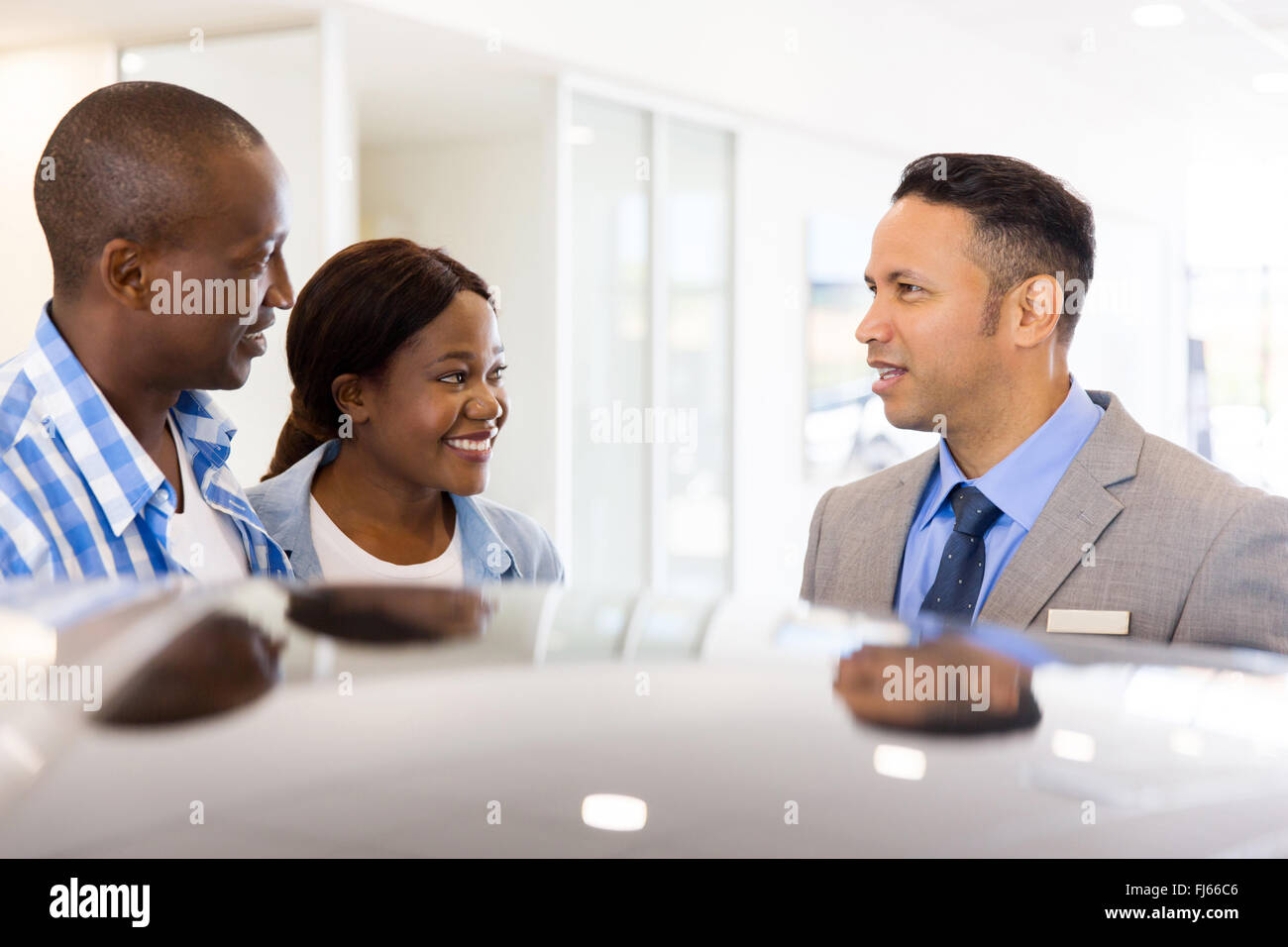 young African couple buying new car at dealership Stock Photo