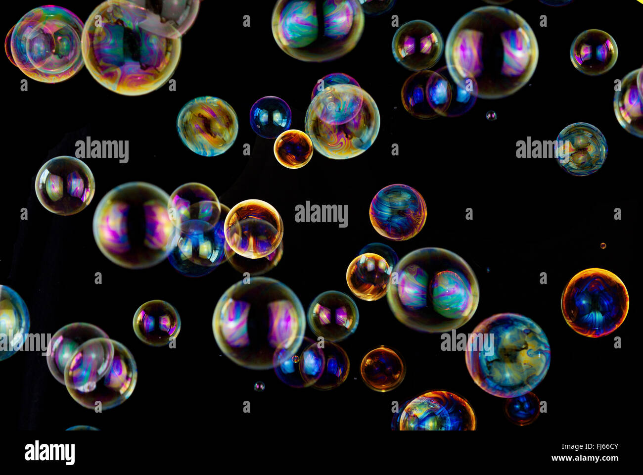 many colorful soap bubbles on black background Stock Photo