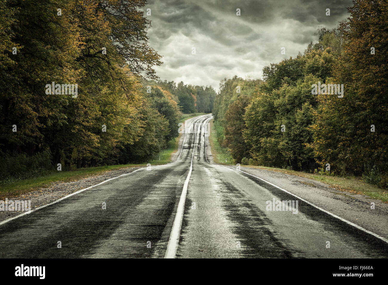 Dark asphalt road under a storm sky Stock Photo - Alamy
