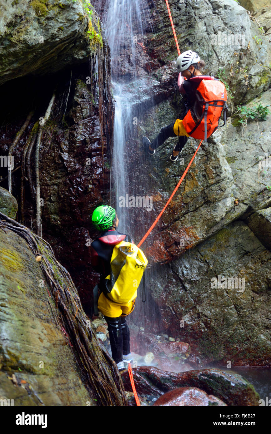 two persons rappelling at a waterfall, canyoning , France, Corsica, Bastia Stock Photo