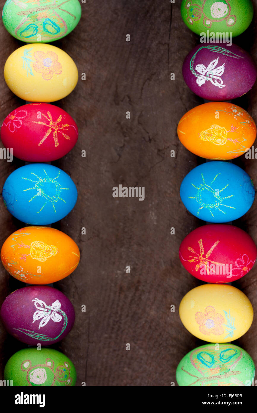Colorful easter eggs on rustic wooden background Stock Photo - Alamy