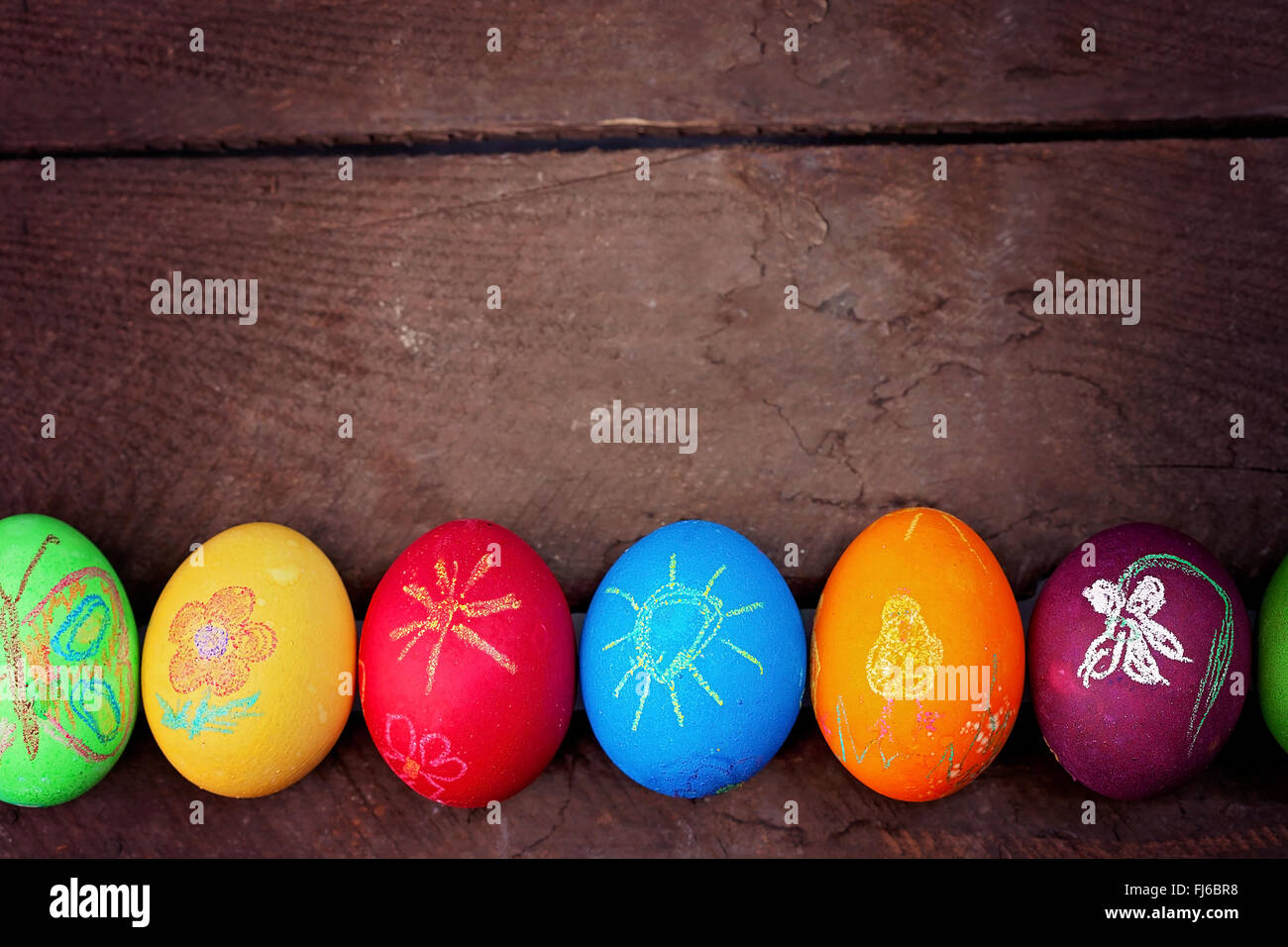Colorful easter eggs on rustic wooden background Stock Photo - Alamy
