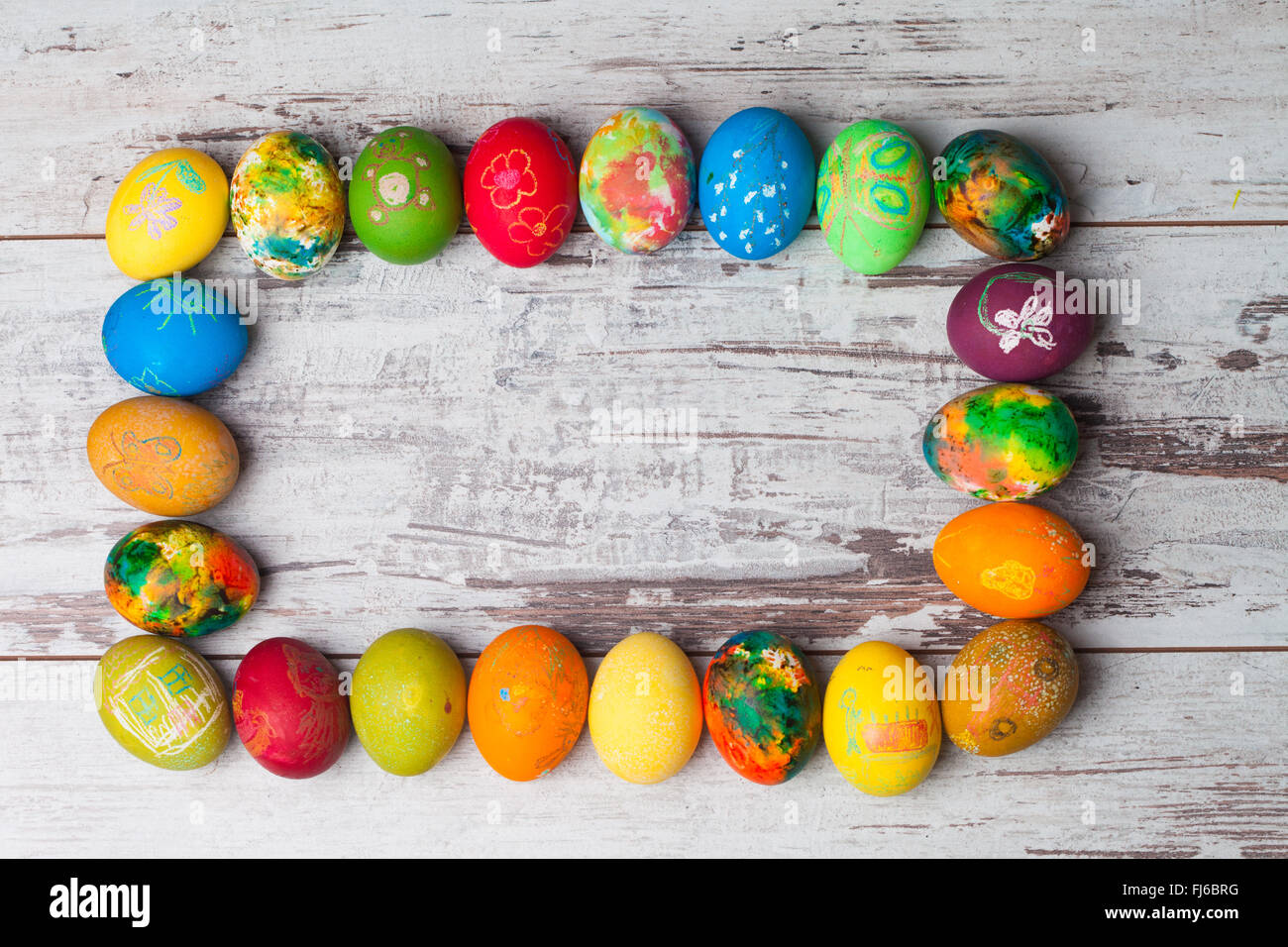 Colorful easter eggs on rustic wooden background Stock Photo - Alamy