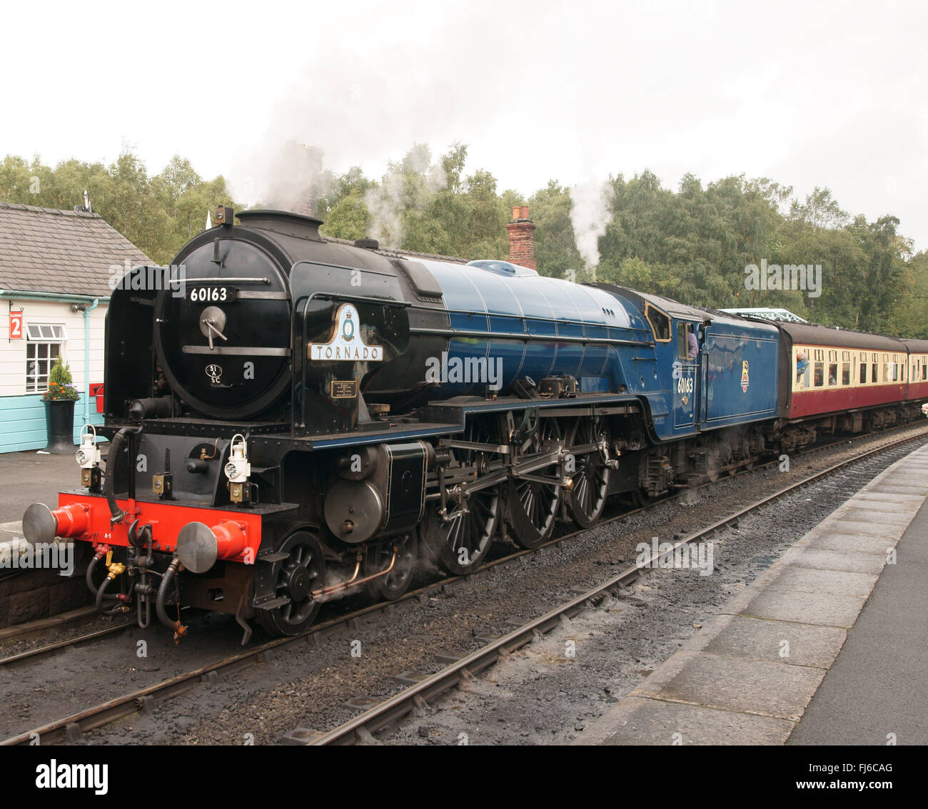 Tornado steam locomotive in BR blue at Grosmont Station platform on North York Moors Railway, three-quarter view Stock Photo