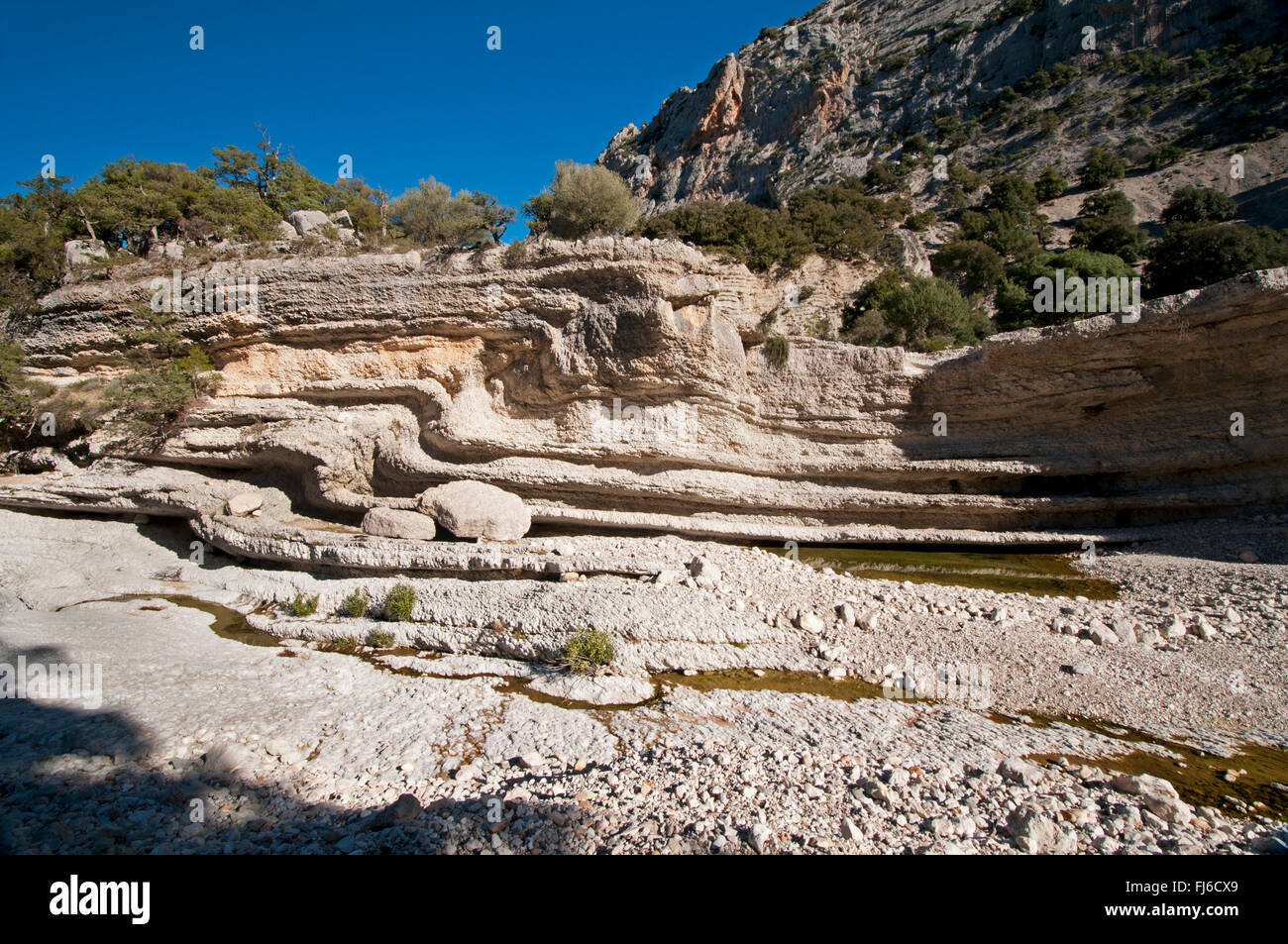 Urzulei,Sardinia,Italy, 01/2015. Limestone rocks and lake of spring water at Giunturas, Gorropu canyon, Supramonte region Stock Photo